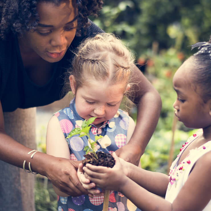adult mother gardening with coas outside